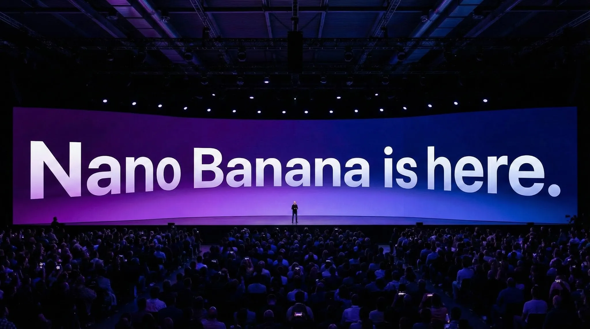 Generate a photo of a grand Apple product launch event with a large audience. The venue is dark and immersive, filled with dazzling stage lighting. The camera focuses on a massive, wide curved screen that dominates the scene. On the screen, display the white gradient text: “Nano Banana is here.” The text follows the same perspective as the curved display, with a subtle 3D depth and realistic distortion.

A very small human silhouette stands on the stage in front of the screen, emphasizing scale and grandeur. The background softly diffuses from deep purple to blue tones, creating a cinematic atmosphere. The overall scene should look like a real on-site photograph from a high-end keynote event, premium, elegant, and technologically advanced. Aspect ratio 16:9.